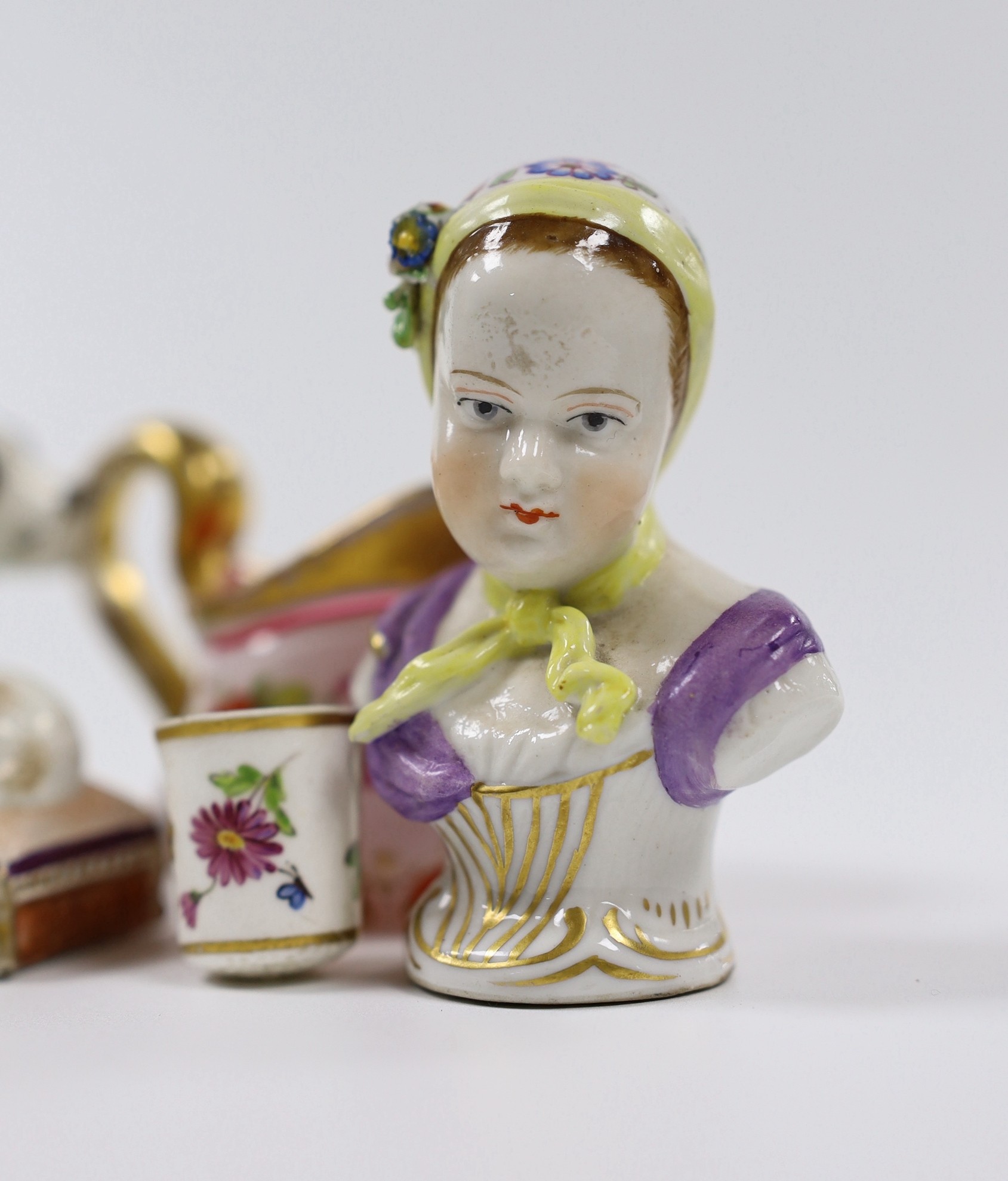An early 19th century earthenware sleeping dog, a Victorian bone china model of a dog, a miniature overlaid glass decanter and ewer, etc. (12)